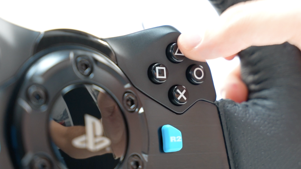 pushing down the buttons on a logitech g29 sim racing wheel